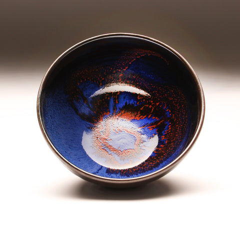 GH256  Medium bowl with Cosmic Blue & Red interior, over Black with chattering